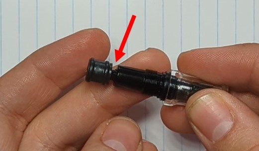A photo showing the Plunger/Collar/Tailcap assembly. The Tailcap is fully tight and has no gap, but there is a 2mm gap between the collar and the Plunger.