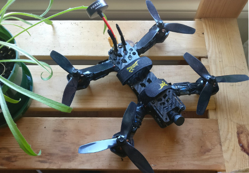 Top view of drone, next to a plant
