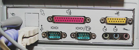 A photo of the IO panel from an old PC, showing many obsolete connectors.