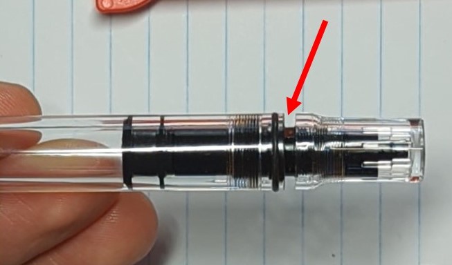 A photo of the tail end of a TWSBI ECO. The Plunger is fully retracted and the tailcap is tight, but there's a 1-2mm gap between the tailcap and the body.