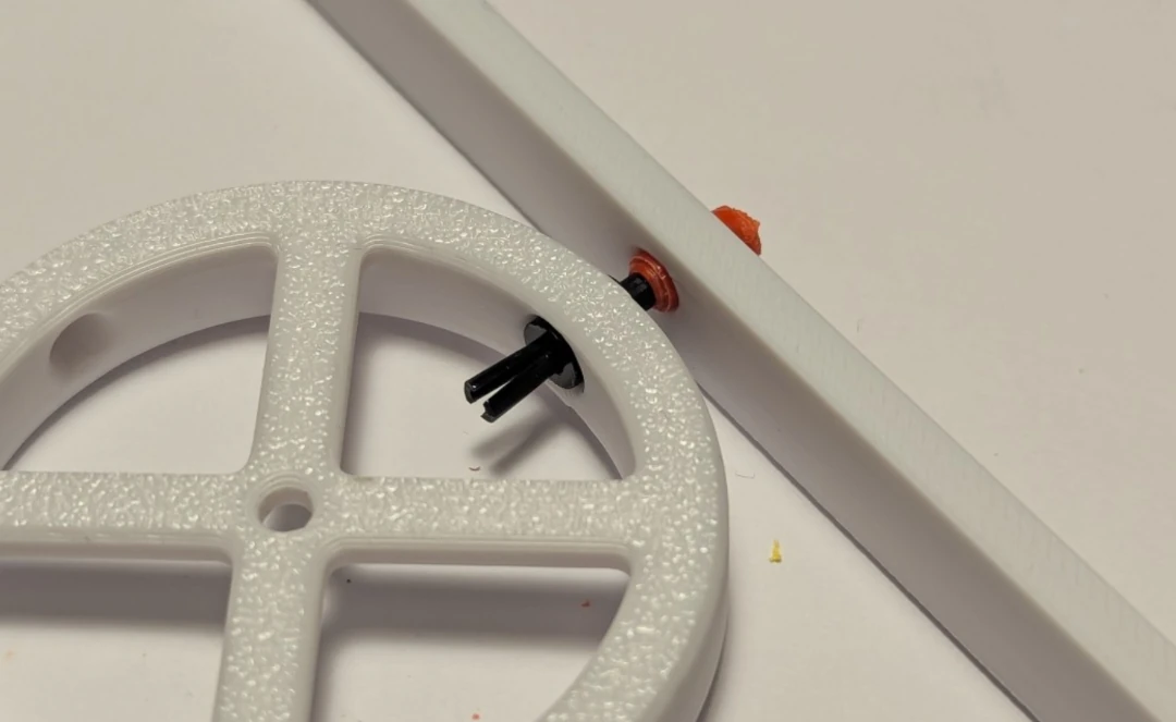 The tip of the pencil and the black collar is used to create a pivot between two 3d printed pieces.